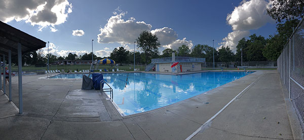 The Oxford pool reflects a cloudy sky on Aug. 31, three days before it will close forever. <em>Photo by Alex MacGregor.</em>