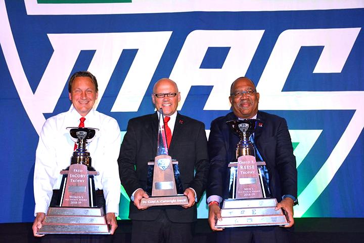 At the MAC trophy presentation in Cleveland on Wednesday, from left to right, Miami Athletic Director David Sayler holds the Jacoby Trophy; President Gregory Crawford holds the Cartwright Award, presented by the Mid-American Conference for excellence in academics, athletics and citizenship; and Ronald Scott, faculty athletic representative, holds the Reese Trophy. <em>Photo courtesy of Miami Athletics.</em><br>