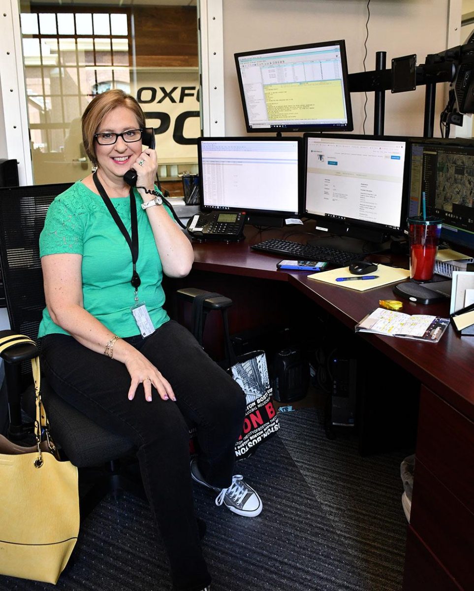 Joann Handley answers calls and greets visitors in the new dispatch room, which has a window facing the waiting area. Photo by Lauren Shassere