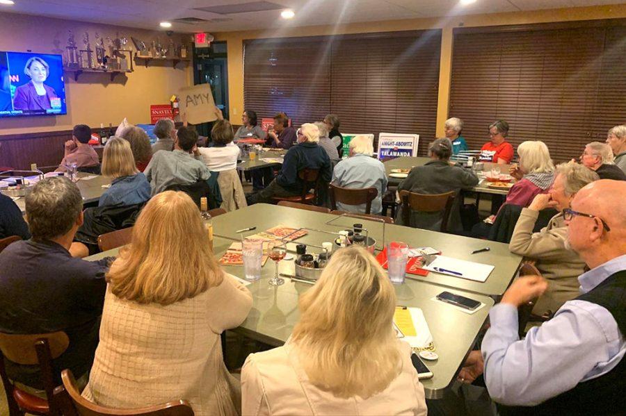 More than 40 people gathered to watch the debate on television, on at the LaRosa’s in Oxford. Audience members showed their support for individual candidates as they came on screen, such as the woman in the front row waving a sign for Amy Klobuchar. Photo by Josiah Collins
