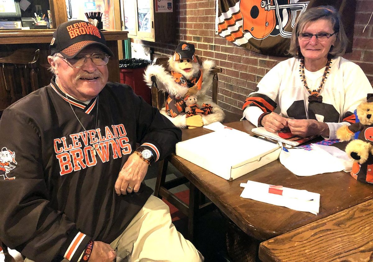 Jim and Geri Schick, pictured with J.J., their lucky charm stuffed animal, have been Browns Backers members since its inception in 1999. Jim now serves as the president of the club. Photo by Massillon Myers