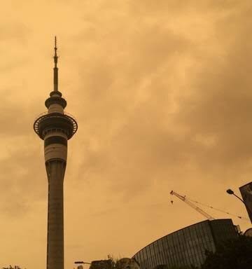 Although it is thousands of miles from the Australian wildfires, the air above the Sky Tower in Auckland, New Zealand reflects the fiery orange of the blaze. <em>Photo by Curtis Herzog</em>