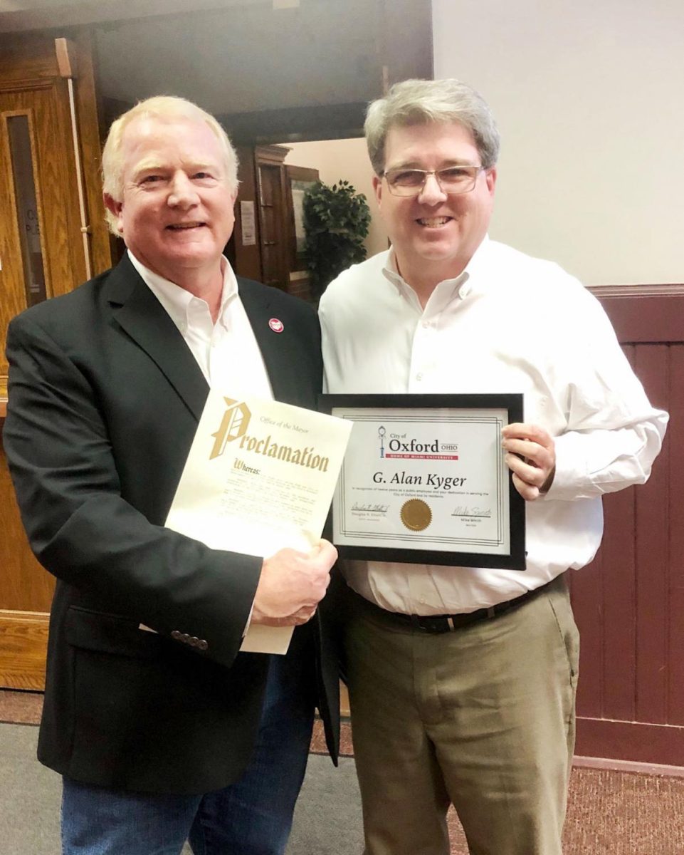 Alan Kyger (left) receives a proclamation from Oxford Mayor Mike Smith declaring March 5 Alan Kyger Day. Photo courtesy of the city of Oxford.