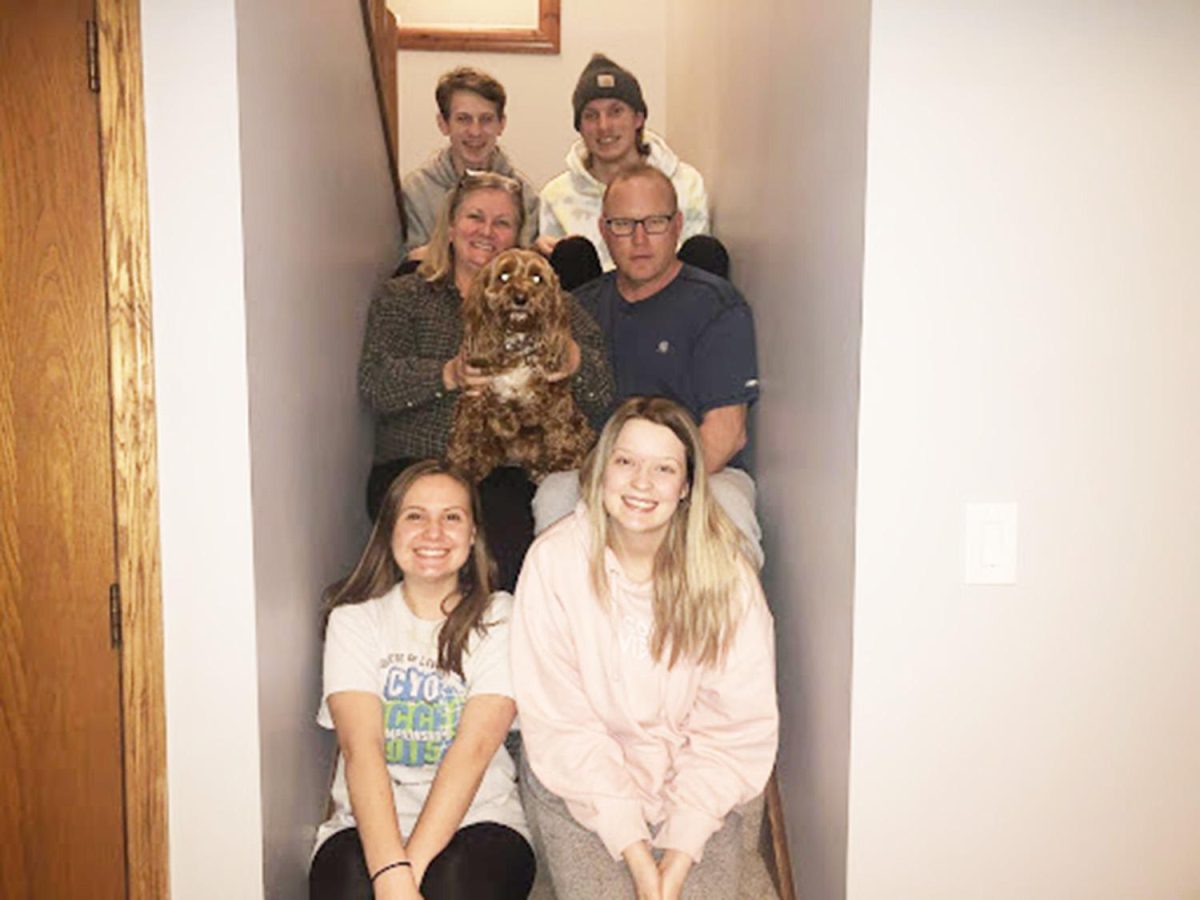 As many members of the Davis-Landgraf family as can, squeeze into a late-night quarantine photo on the stairs. Photo by Jenna Landgraf