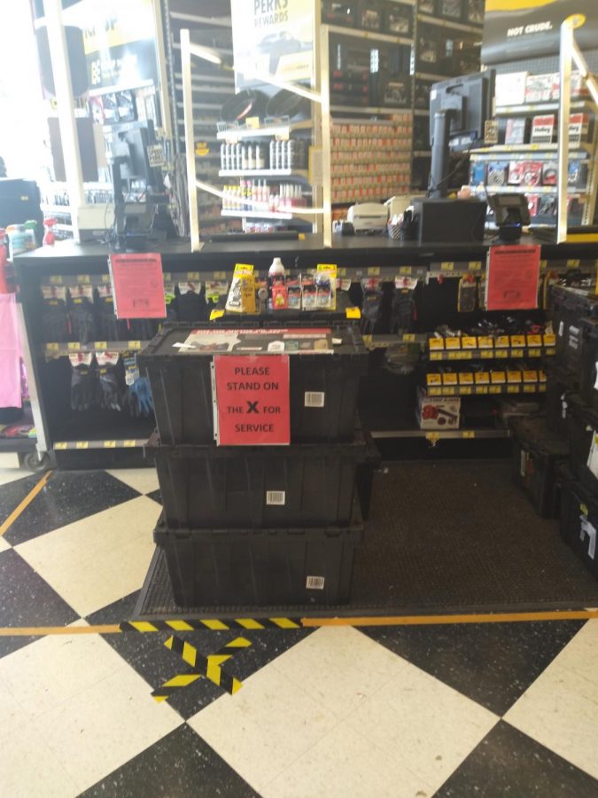 Plastic cases force customers to stand back from the counter, which is shielded with plexiglass barriers at Advance Auto Parts in Eaton. Photo by Drew Edwards