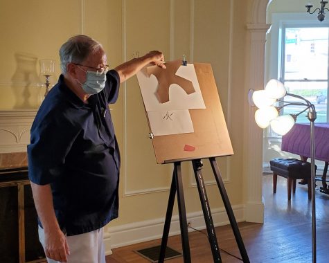 Howard Krauss, a local watercolor artist, teaches his class while wearing a mask