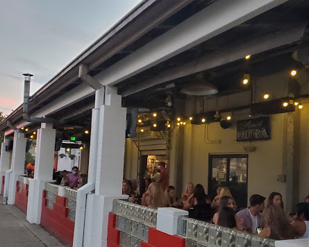 Customers fill the patio tables outside of Brick Street Bar, Uptown this week.