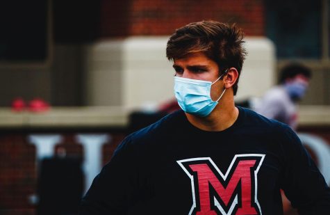 Miami quarterback Brett Gabbert calls the signals while wearing a mask. 