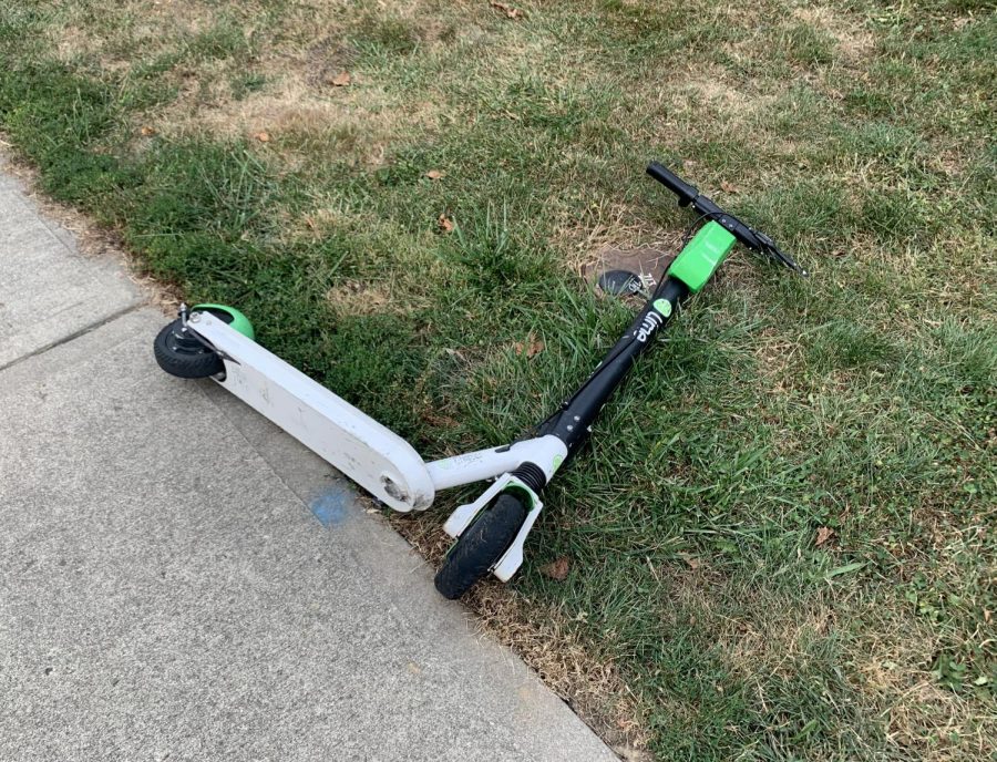 Lime scooter parked improperly on the sidewalk of Main Street