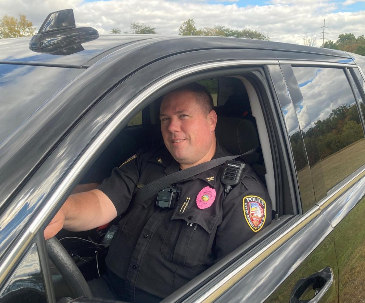 Oxford Police Chief John Jones is one of several members of the department sporting pink badges in support of Breast Cancer Awareness Month.