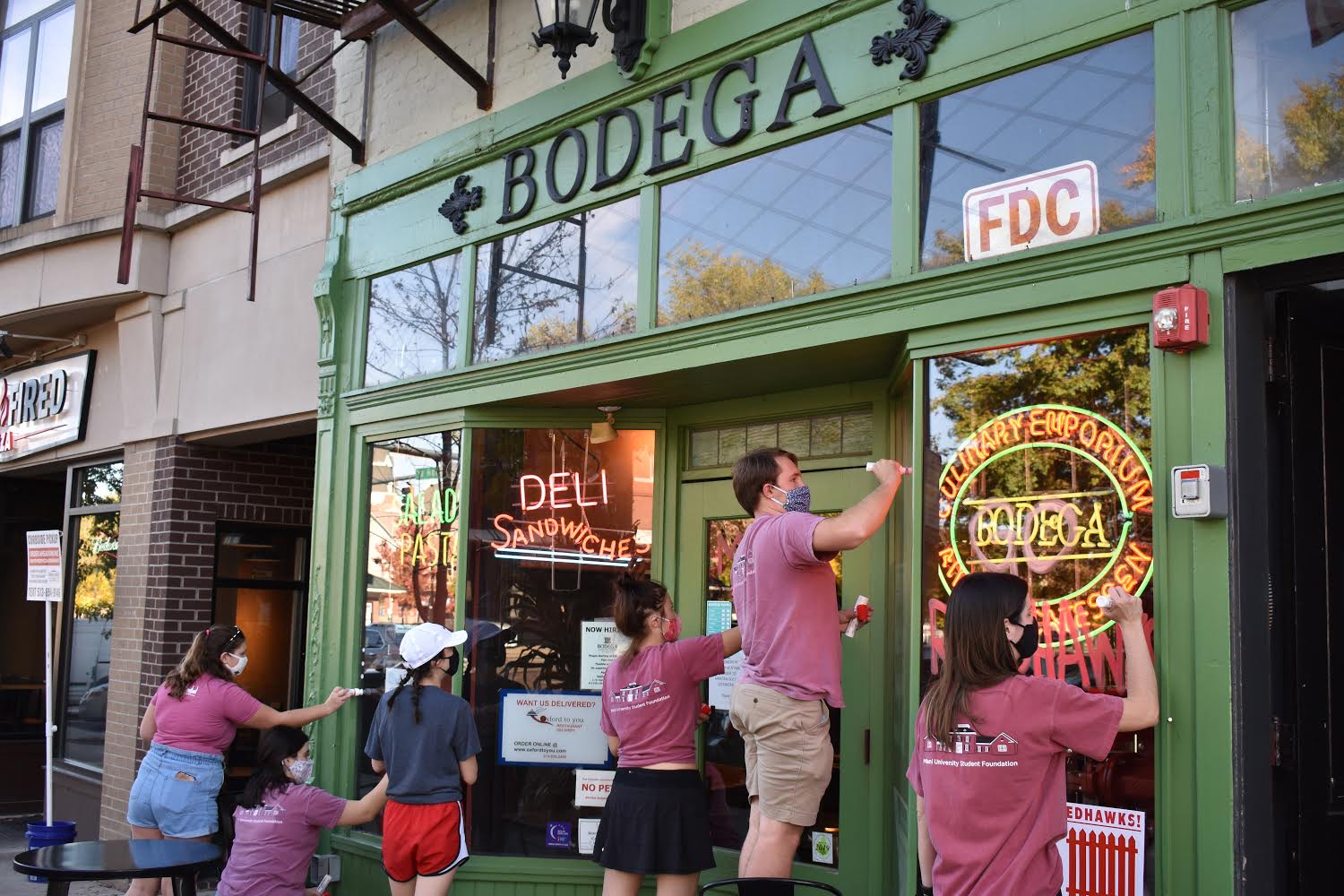 Volunteers "Painting the Town Red" in preparation for Homecoming and Family Weekend