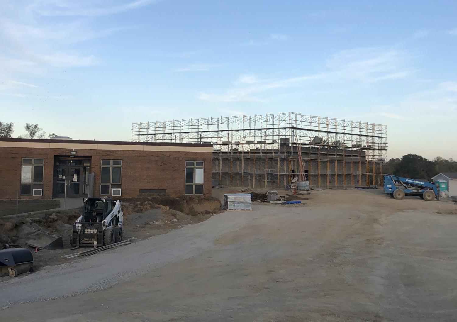 The new school is going up next to the old school, which is still in use