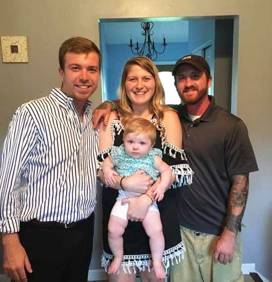 Michael McKenney, a missing person, pictured (on the right) with his sister and brother