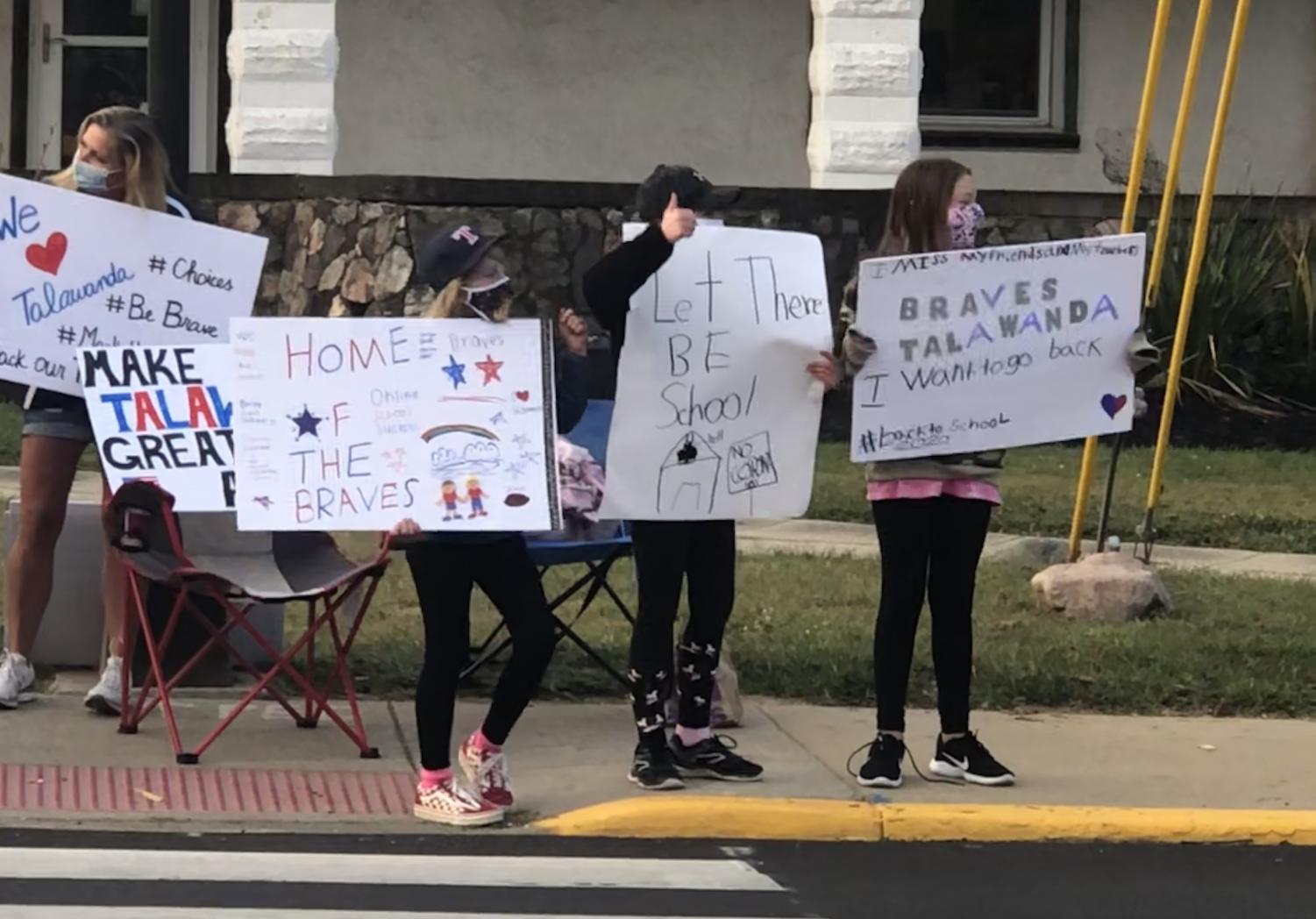 A group of parents protest the school board's decision to move classes online in September