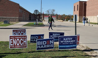 Voters greeted with a crop of campaign signs as they arrive at Talawanda High School to vote.