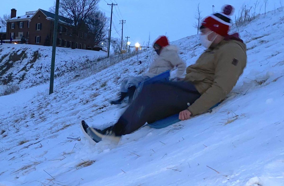 Snow can be fun too, as Miami students Jacob Terwilleger and Meredith Horn can attest as they slide down the Peffer Park hill on makeshift sleds late Wednesday.
