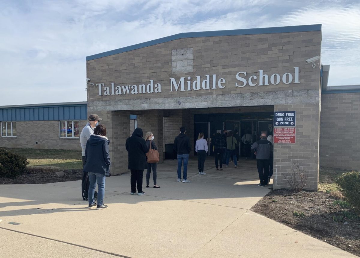 People line up to get their COVID-19 vaccinations outside of Talawanda Middle School, Wednesday afternoon.