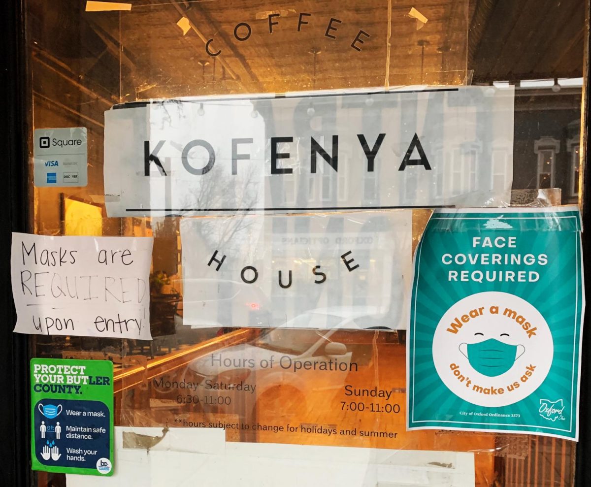 State and local regulations require masks to be worn inside all local business, as attested to by these signs in the window of the Kofenya Coffee House, 38 W. High Street.