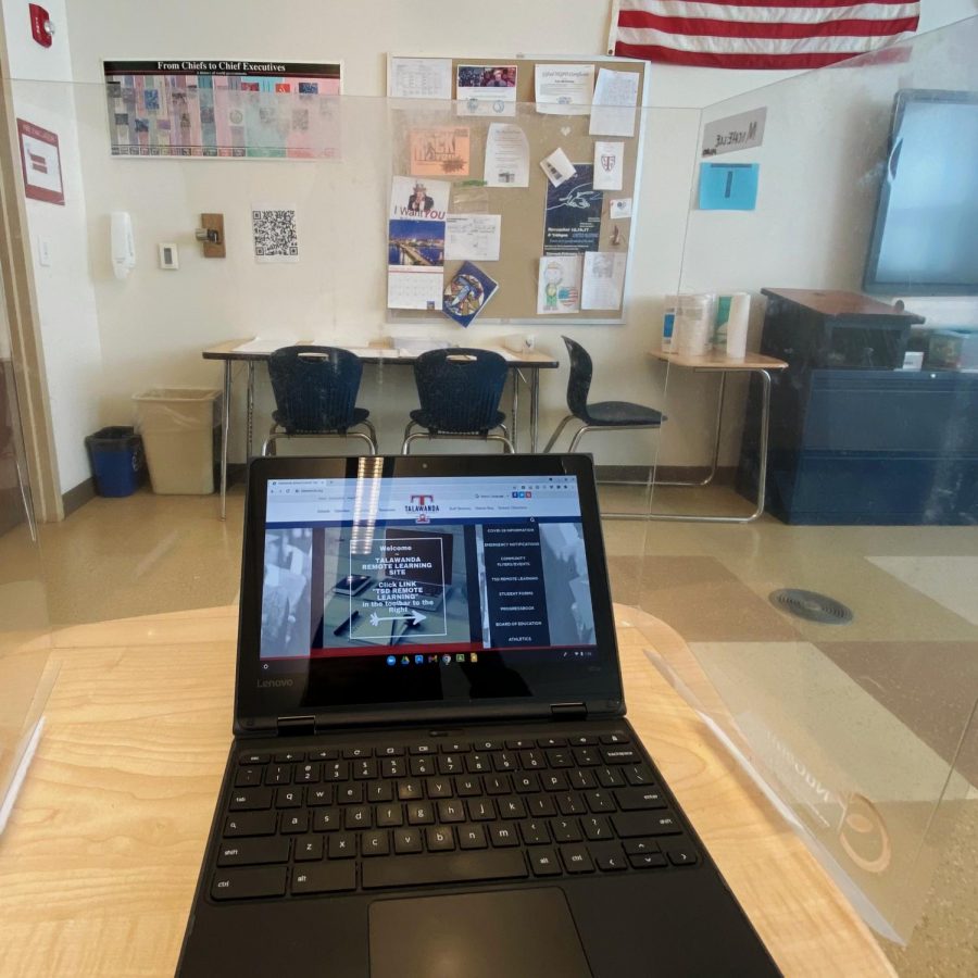 Families were given the choice of sending their children back to the classrooms in Talawanda Schools for spring semester. About 80% chose to have students study in school, where desks such as this one are surrounded by plastic shields. The other 20% attend classes virtually by signing into the district’s remote learning program – as shown on the computer screen in this photo.