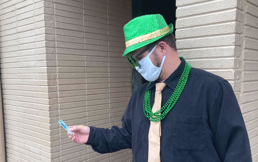 Brian Urell on Green Beer Day 2021, in one of many eccentric outfits for special holidays and popular drinking occasions, while checking IDs as a doorman at local bars. 