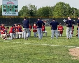 The varsity Brave team took a knee to hear from the coaches after losing to Harrison in the conference tournament.