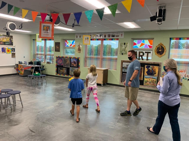 Aaron Weekley, father of a fifth grader and second grader who will be attending the school, admire the art room Thursday. 