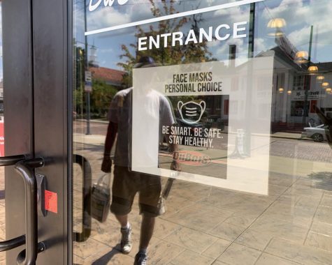 Signs such as this one on the door of Dubois Book Store, 118 E. High St., indicate that customers have a choice about wearing masks inside. An emergency ordinance will be considered at a special Oxford City Council meeting on Monday that would make masks mandatory. 