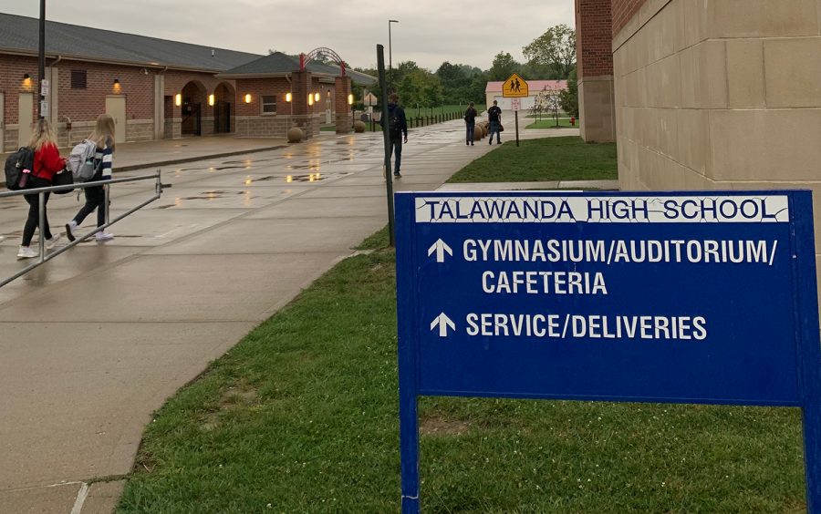 Once they enter the building, Talawanda High School students take off their coats and put on their masks.