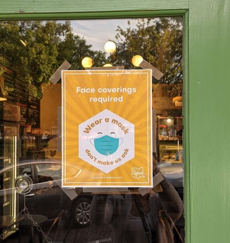 Signs such as this one on the door of La Bodega restaurant, 11 W. High St., were distributed through the city to businesses all over town this week after city council passed a mask mandate. 