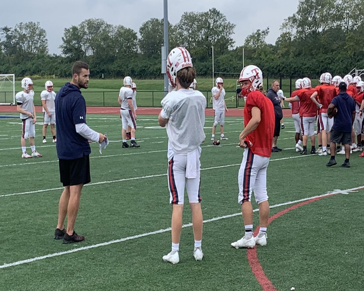 Talawanda’s new football coach Jay Volker (in black) at a recent practice says he believes in being tough on the field and compassionate off the field. 