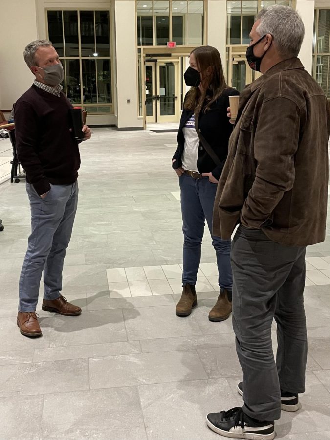 Councilman David Prytherch (left) talks to community members Lexi Mash and Dana Miller after the event during a reception hosted by the Wilks Institute. All four city council candidates stayed to talk with the audience.