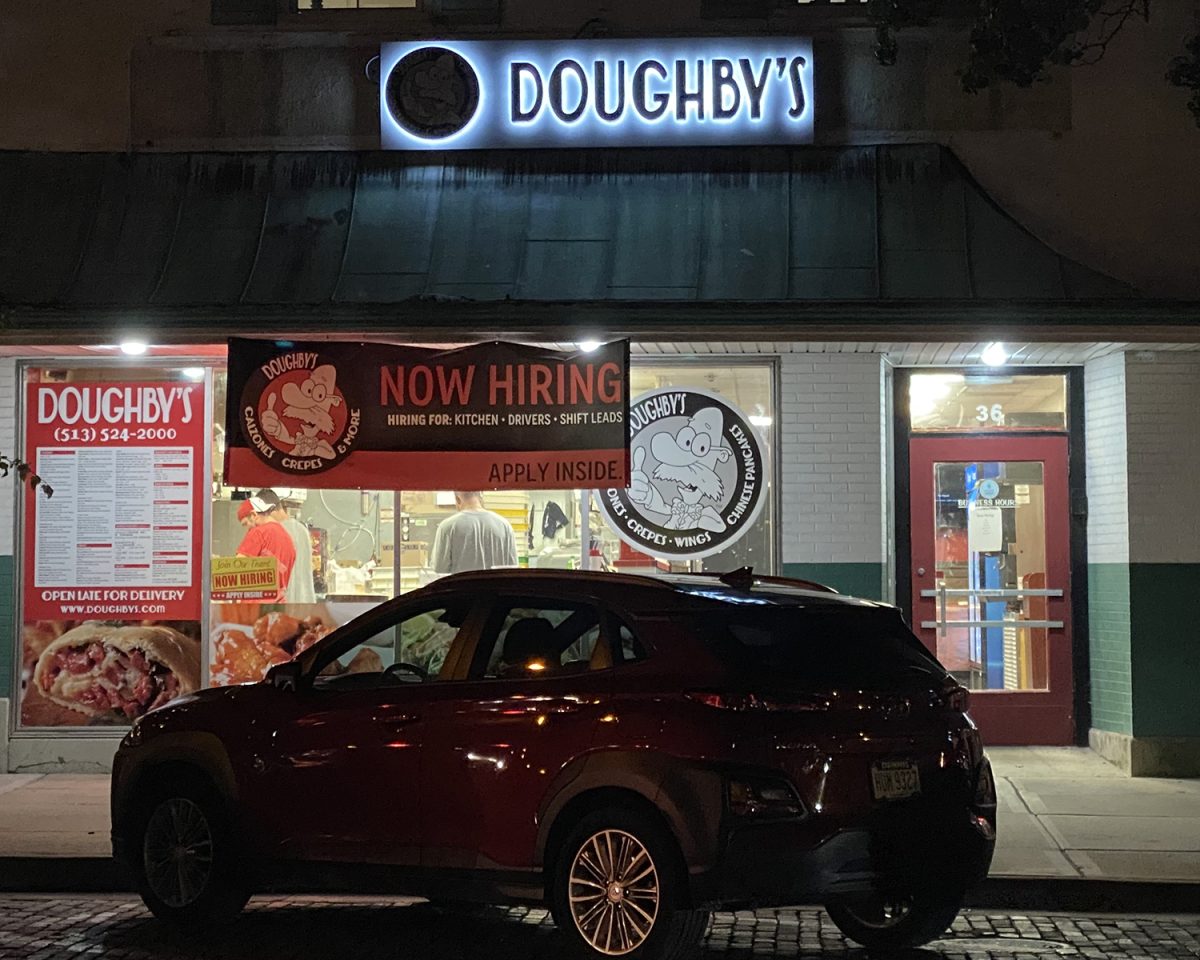 The “Now Hiring” sign is the most prominent display in the window of Doughby’s, a popular High Street eatery that can’t get enough help. 