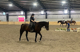 Equestrian team members practice in the middle of Miami’s new indoor riding arena for a lesson at the indoor arena. 