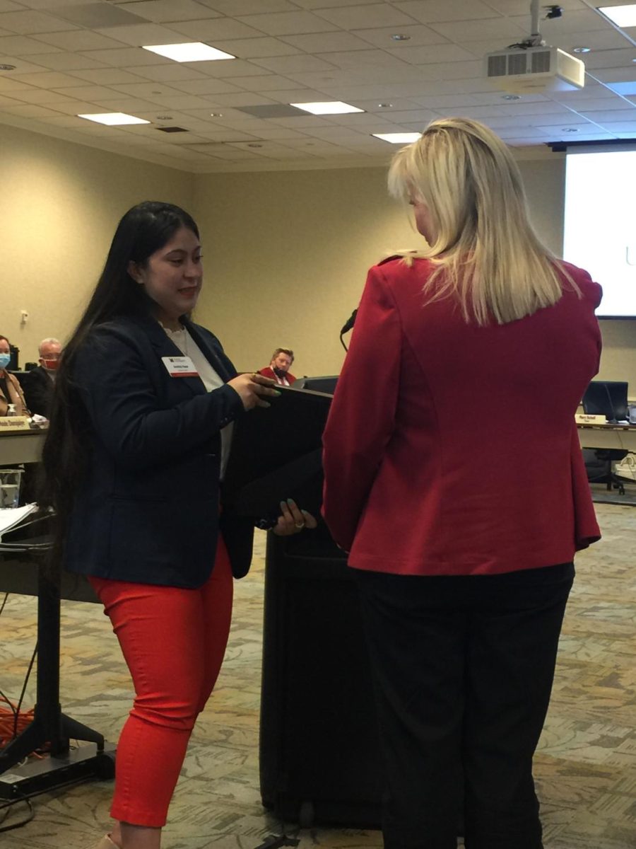 Mary Schell, who took over Friday as chair of the Miami University Board of Trustee, thanks Miami junior Amitoj Kaur (left) for her two years of service as a student trustee. 