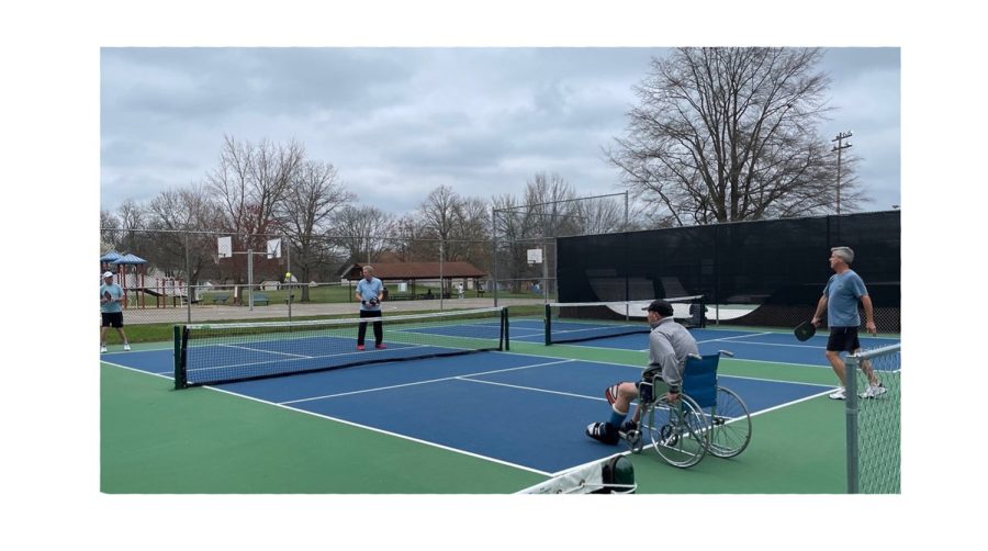 Residents of Oxford use the pickleball courts at TRI Community Center, which offer free public access on a first-come first-served basis. David Wespiser (far right) doubles partner Dan Purcell, who is playing from a wheelchair because of recent ankle surgery. 
