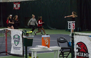 he Miami tennis team celebrates with Emilia Valentinsson (right with arms outstretched) after her match-deciding victory against Eastern Michigan.