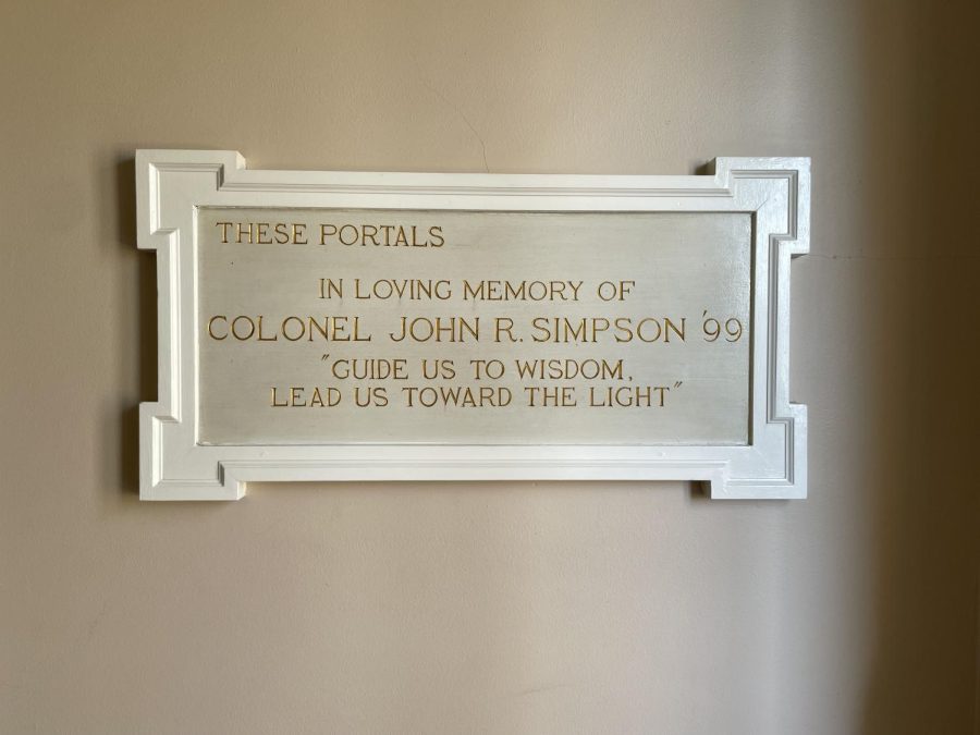 As noted in the corresponding story, a plaque with a white frame on the wall of the chapel narthex is dedicated to the memory of alumnus Colonel John R. Simpson with an accompanying quote. 