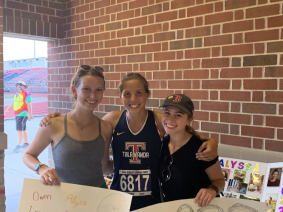 Hannah Lippincott (center) with friends Ellie Garland (left) and Carly Goodman (right) at a recent track meet. 