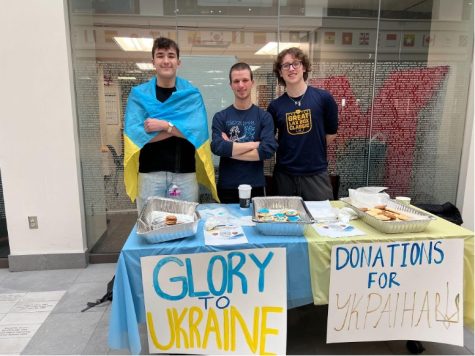 Nikita Kornyushenko (left), Roman Jakubowyc and Nick Jarosewich (right) in front of their table during their bake sale.