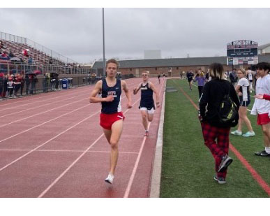 Jacob Farmer passes his opponent on the way to winning the 1,600-meter race.