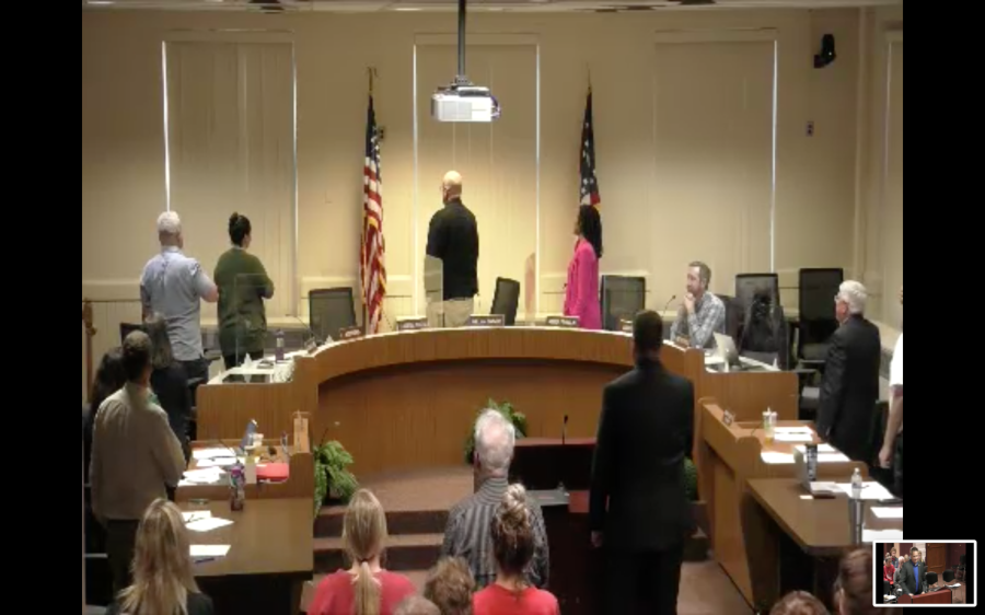 Oxford City Council reinstated the Pledge of Allegiance on its agenda and at the request of a member of the public, stood and recited it at its May 3 meeting. Council Member Jason Bracken (plaid shirt at right) voted against the resolution and remained seated. 

