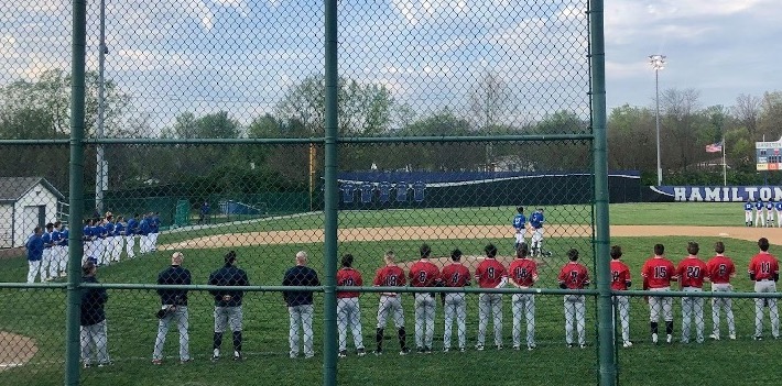 Talawanda and Hamilton line up along the baselines before the first pitch on April 30.