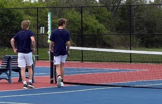 Aiden Bruder and Bryce James switching sides after a set. 