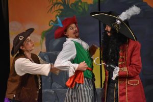 Captain Hook (Toby Seals) threatens Smee (Joah Brier) and Starkey (Calvin Thomas) after they release Tiger Lilly from the rock. 

