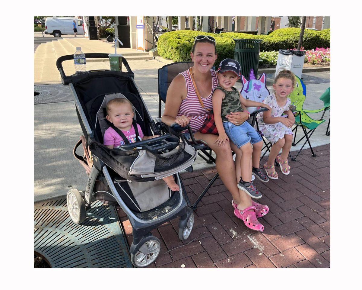 Ruthlene Russell from Oxford and her children attend the Fourth of July parade uptown Saturday. From left, Brooklyn (who celebrated her first birthday Saturday), Cason on her lap and Bailey on the right. Photo by Sacha DeVroomen Bellman