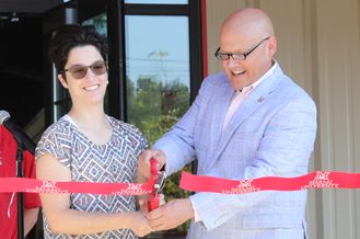 Miami University President Greg Crawford shakes hands with equestrian team president Catherine Wasylyshyn 22 at a dedication ceremony for the Equestrian Centers new indoor facility on Aug. 22, 2022.