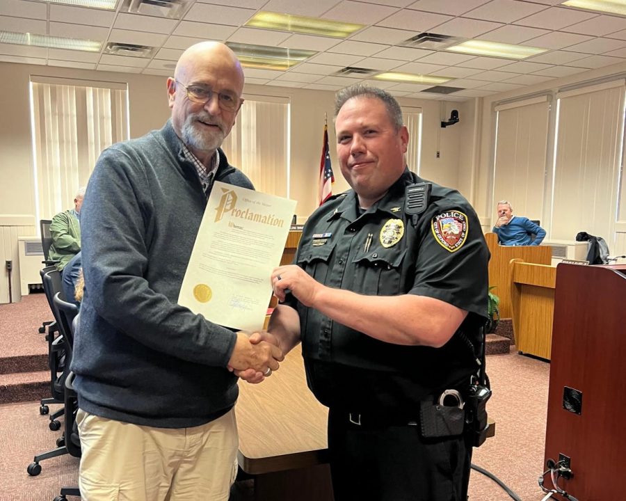 Mayor William Snavely presents Chief John Jones with the proclamation of police week in Oxford. 