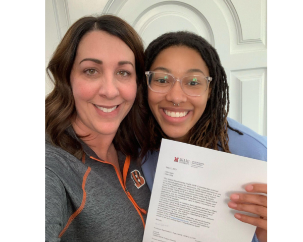 Miami social work major Alia Agee poses with an acceptance letter to the internship program with her stepmother Cindy.
