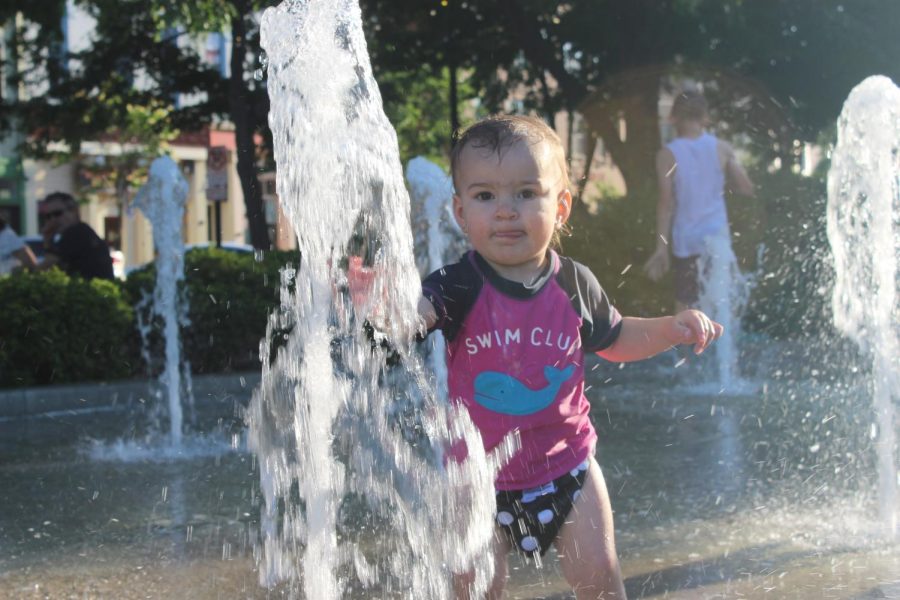 Delaney Stapleton, 20 months, plays on the splash pad during the concert.
