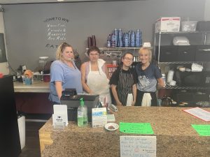 Angie Hunter, right, stands with her three Hometown Eatery employees.